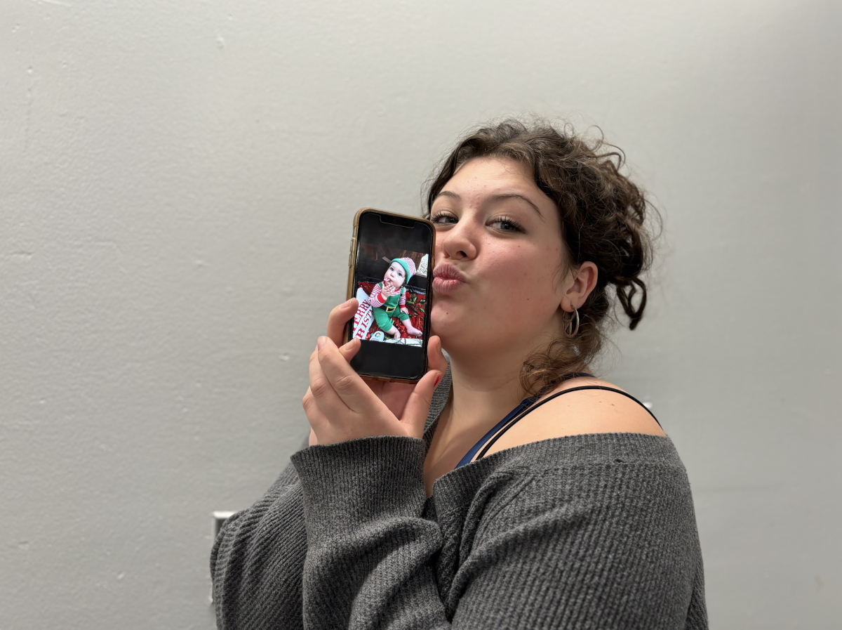 Ellie Robbins holds up a picture of her youngest brother, Mackenzie.